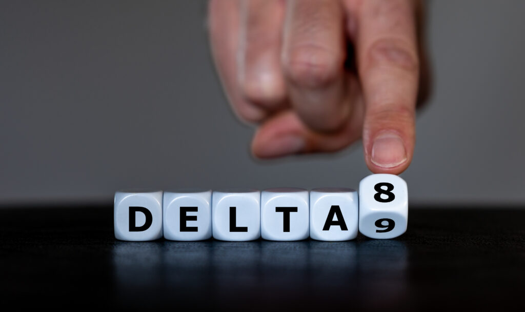 Hand turns dice and changes the expression 'delta 9' to 'delta 8